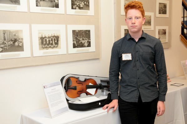 Next Chapter student Ethan with the violin he purchased for his survivor