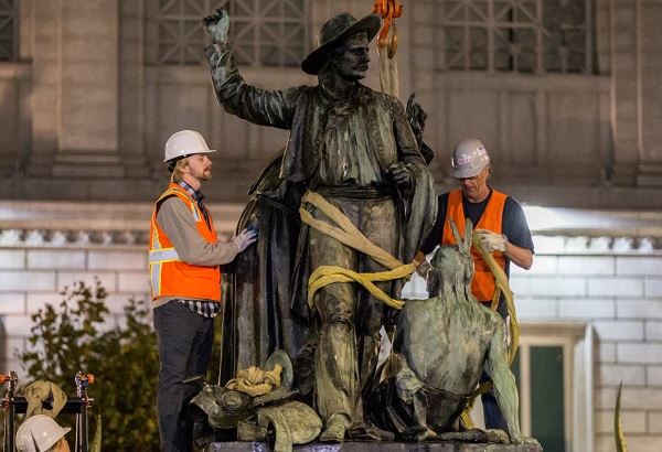 Workers removing the Early Days statue on the morning of Sept. 14, 2018.